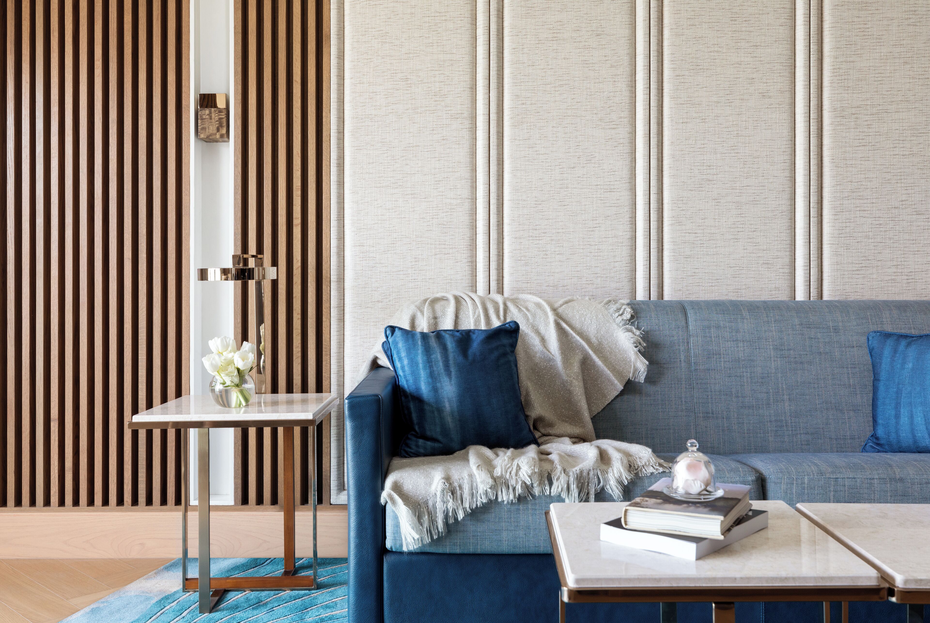 A modern living room with a sofa, a side table, and a coffee table.