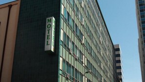 A modern building with a sign that reads "Motel." - The Mac Boutique Hotel (Adelaide)