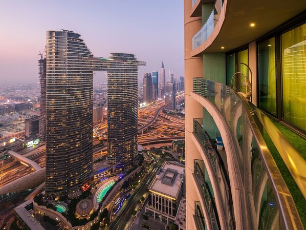 A high-rise building with a curved facade, multiple floors, and a view of the surrounding cityscape.