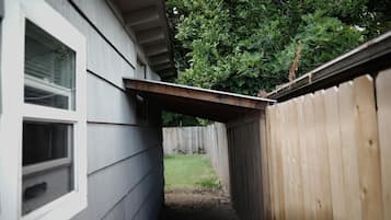 A wooden fence and a house with a window.
