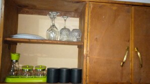 A wooden cabinet with glassware and jars. - White House Mtwapa (Mtwapa)