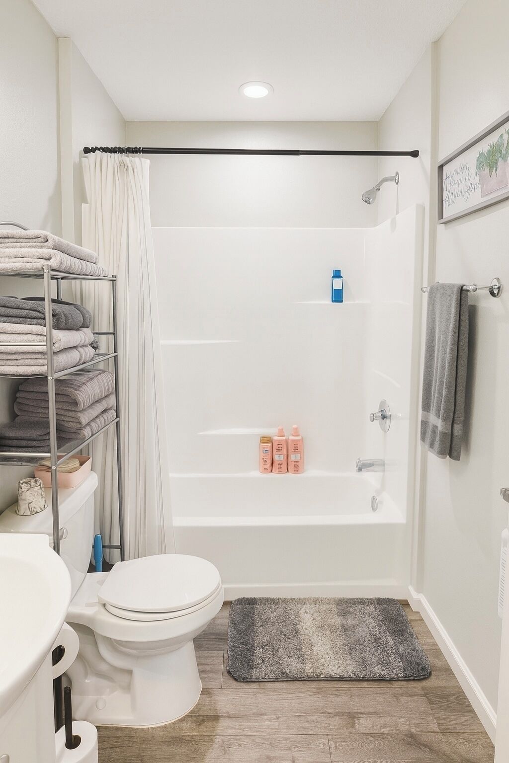A modern bathroom with a shower, toilet, and a towel rack.