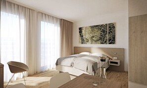 A modern hotel room with a large bed, a desk, and a chair. There is a window with curtains, a map artwork on the wall, and a nightstand with a lamp. - Myhome Munich (Munich)