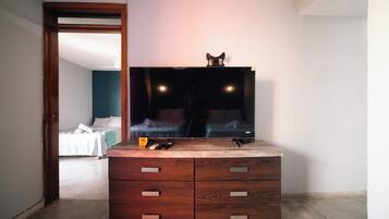 A wooden dresser with drawers, a mirror, and a small table with items on top.