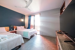 A bedroom with two beds, a ceiling fan, a nightstand, a dresser, and a window with curtains. - Zihua Mia Hotel Boutique 6 (Zihuatanejo)
