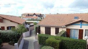 Un barrio residencial con casas de techo de tejas y un estrecho sendero entre ellas.