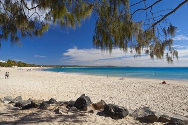 Relax on the beach with stunning ocean views and scenic rock formations.