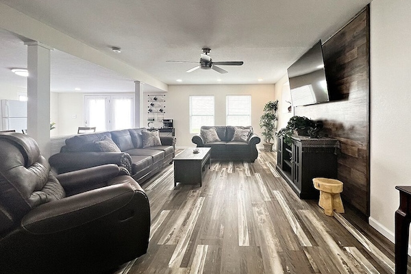 Living Room with love seat, couch and recliner to sit and relax on.