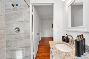 Combined shower/bathtub, hair dryer, soap, toilet paper