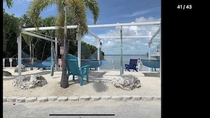 A beach with a swing set, palm trees, and a view of the ocean. - Perfect little paradise spot in key largo Florida.     (lot 15) (Key Largo)
