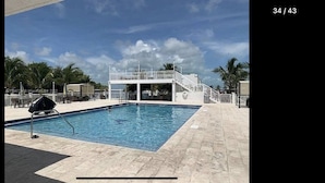 A swimming pool with a covered area and a barbecue grill. - Perfect little paradise spot in key largo Florida.     (lot 15) (Key Largo)