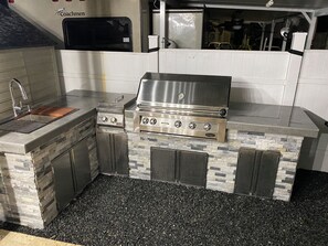 A kitchen with a built-in grill, a sink, and a microwave. - Perfect little paradise spot in key largo Florida.     (lot 15) (Key Largo)
