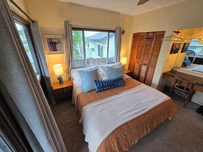 A bedroom with a bed, nightstands, a desk, and a wardrobe. - Palm One Surf House, The Heart of Hanalei, TVNC#  5125 (Hanalei)