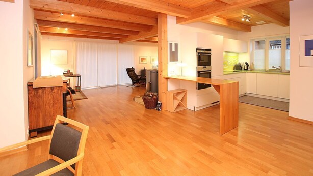 A modern kitchen with wooden cabinets, a countertop, and a built-in oven. - Am Grünstreifen 29, Haus Liguster Whg. no. 1 - vacation apartment in 2-family house, approx. (Wyk auf Föhr)