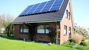 A house with a sloped roof, solar panels, and a brick exterior. - Linge 4, Whg. 1, Hygge - vacation apartment with garden, total of 6 rooms, 4 bedrooms (Wrixum)