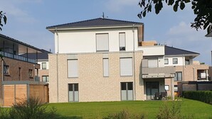 A modern two-story residential building with a flat roof, large windows, and a visible balcony. - 2401 - Strandwiese - Apartment 2401 in the Strandwiese (Dahme)