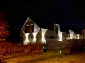 A house with a triangular roof and a garage.