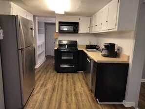 Enjoy cooking in this fully equipped kitchen with a refrigerator, microwave, stove, and sink.
