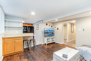 Cozy living space with a kitchenette, flat-screen TV, and comfortable seating area.