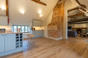 Relax in this inviting living area with a comfortable sofa, fireplace, and kitchenette.
