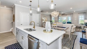 A modern kitchen with a central island, stainless steel appliances, and pendant lighting. - Premium Pet Friendly Townhouse at Lost Key Resort | Balcony w/Gulf Views | Beach Club |Pools (Pensacola)