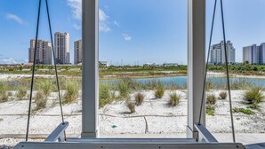 A beach view with a wooden structure, sandy beach, and high-rise buildings in the background. - Premium Pet Friendly Townhouse at Lost Key Resort | Balcony w/Gulf Views | Beach Club |Pools (Pensacola)