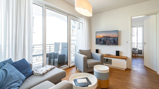 A modern living room with a sofa, armchairs, a coffee table, and a TV. - Quartier 7, App. 07, Germany (Heringsdorf)