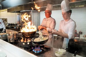 Chefs cooking with flames in a professional kitchen. - Emre Hotel And Emre Beach Hotel (Marmaris)