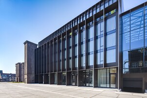 A modern building with large windows and a brick facade.