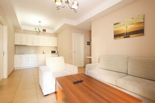 Apartment, 2 Bedrooms, Balcony | Living area | 32-inch LCD TV with cable channels