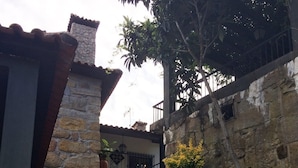 A stone staircase leading to a building with a tiled roof.