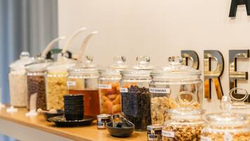 A food display with various jars labeled with contents like 'Dried Banana' and 'Almonds'.