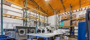 Convenient laundry facilities feature industrial-grade washers and dryers, along with ample storage for linens.