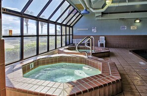 Relax by the pool with a view of the surrounding landscape through large windows.