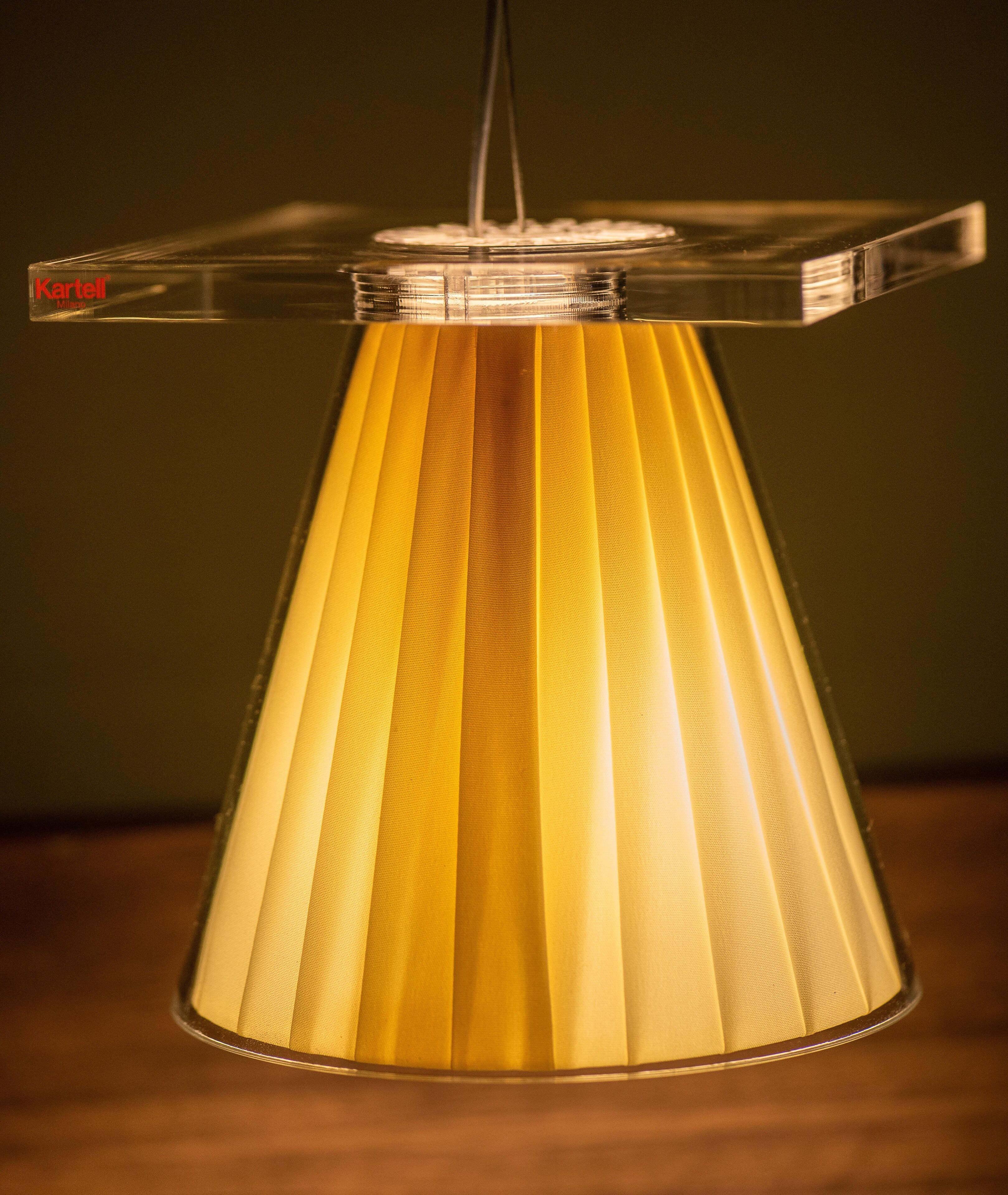 A hanging lamp with a clear, geometric shade and a visible brand name.