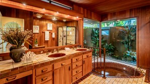 A wooden bathroom with two sinks, a large mirror, and a glass-enclosed shower area. - Bluewater Retreat - Ocean Views from the heart of Santa Barbara (Santa Barbara)