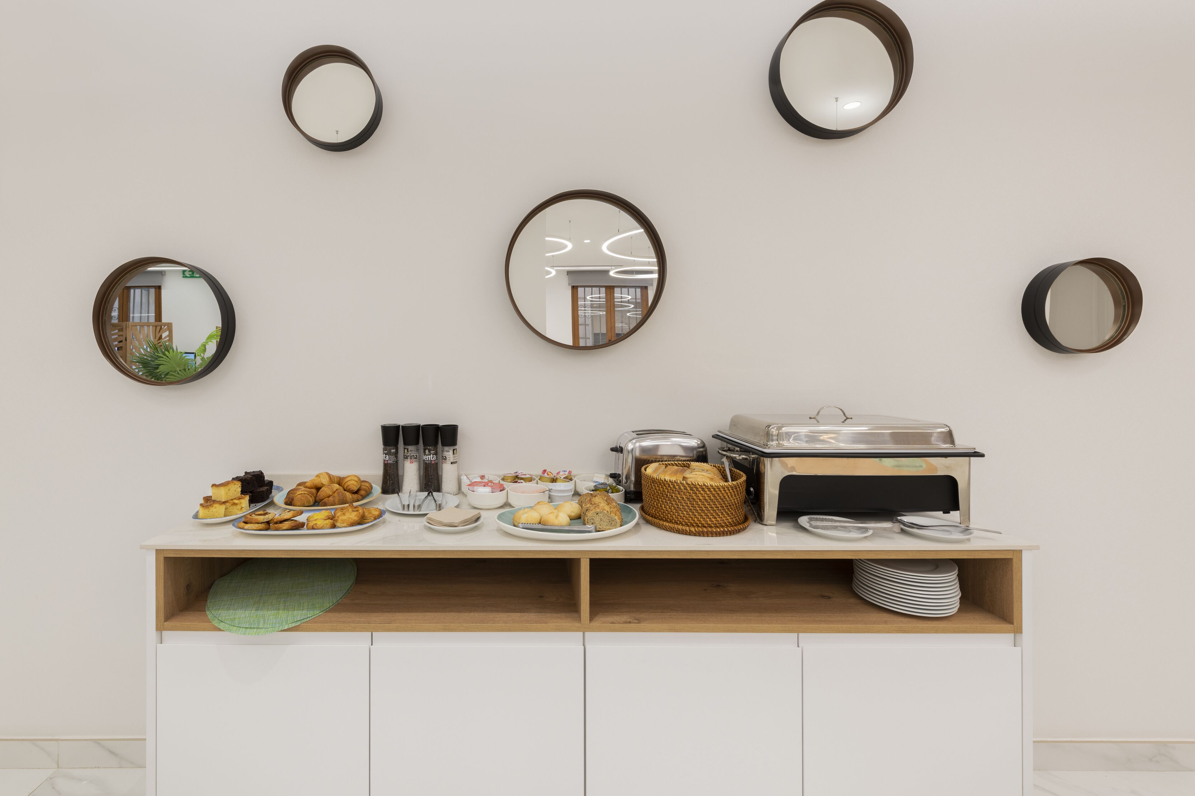 A breakfast buffet setup with various food items and a coffee station.