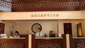 A reception area with a clock and a sign that reads "RECEPTION".