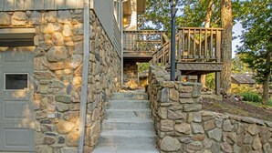 A stone staircase leading to a wooden deck with a railing. - Private Hot Tub and Resort Amenities Included! (Massanutten)