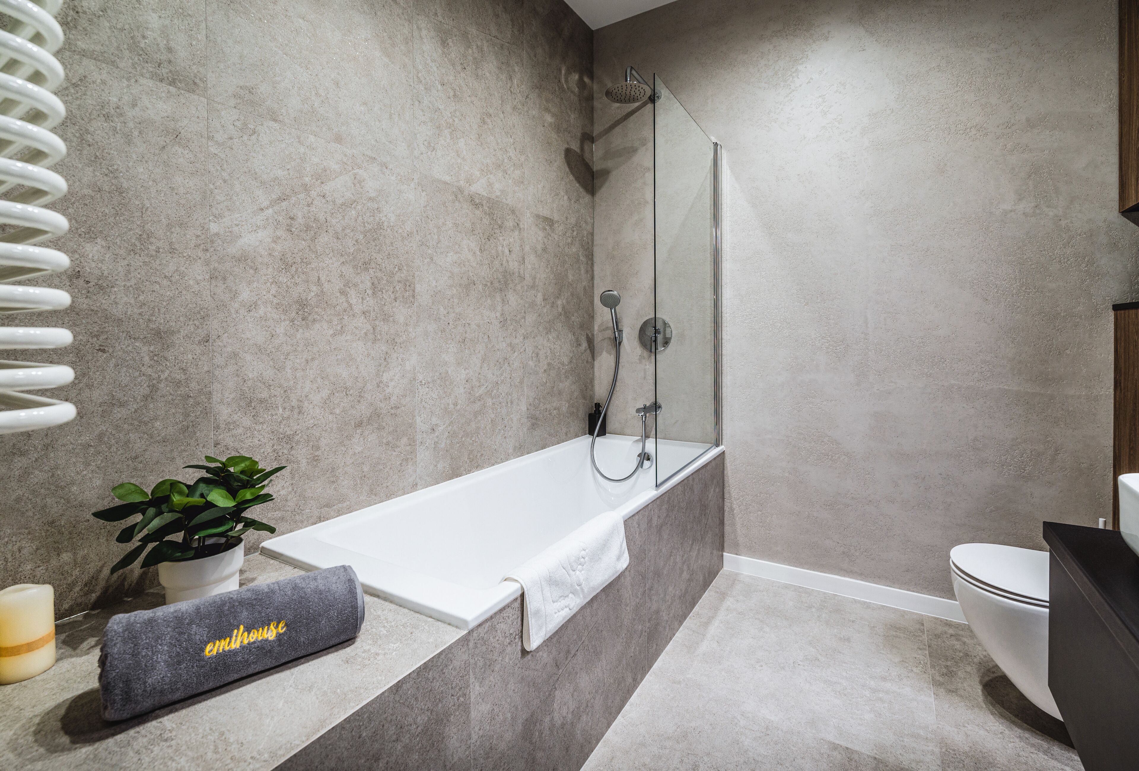 A modern bathroom with a freestanding bathtub, a shower, and a toilet.