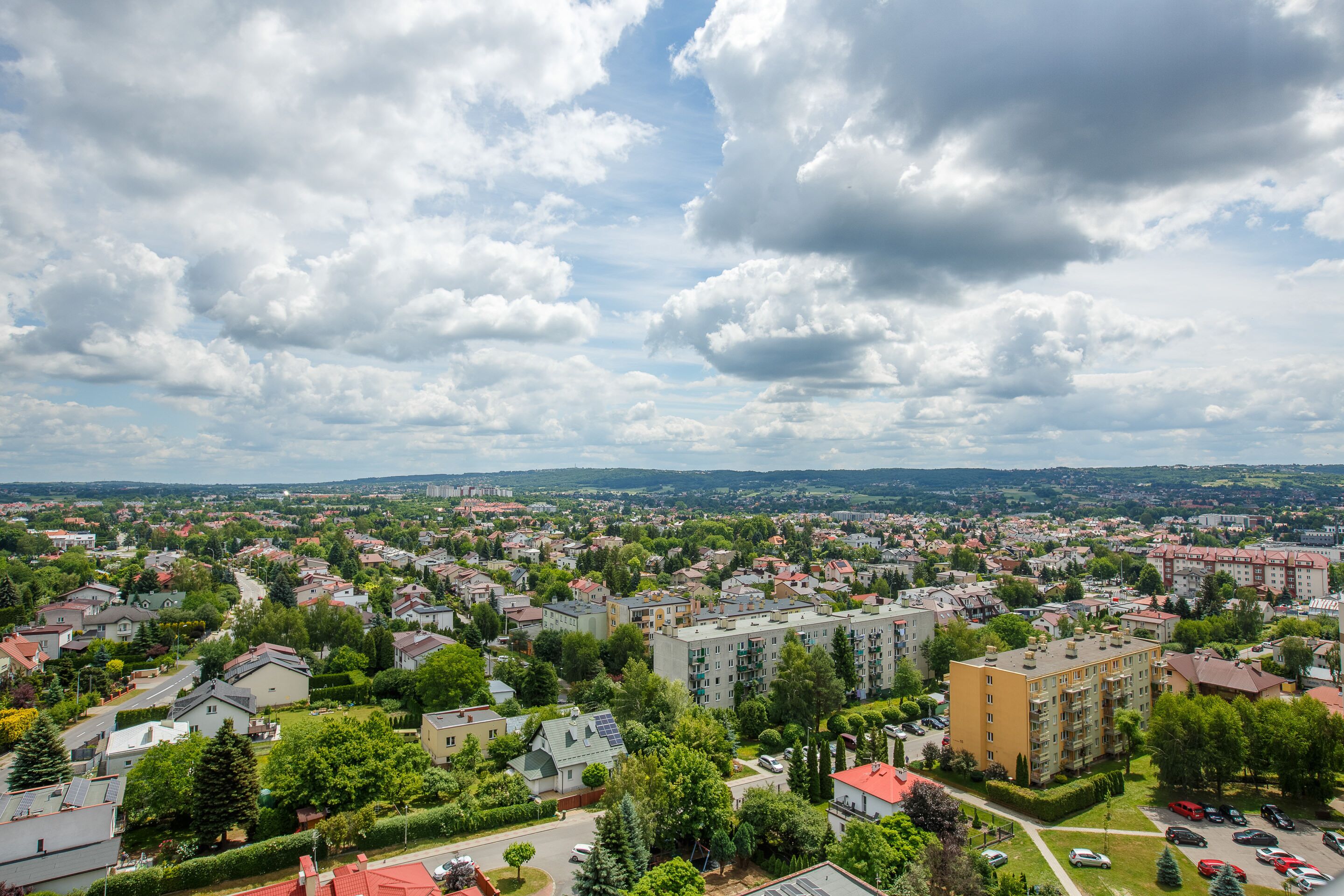 A residential area with multiple apartment buildings, roads, and greenery.
