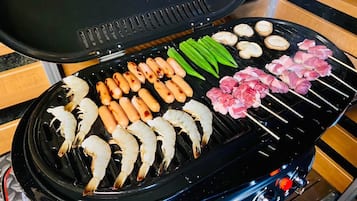 A grill with various meats and vegetables.