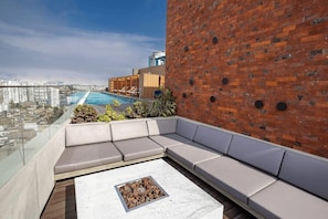 A rooftop terrace with a pool, seating area, and a view of the city. - w* | Magnificent 2BR in Barranco (Cercado de Lima)