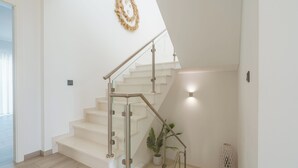 A modern staircase with glass railings and a white interior. - Silver Villa with ocean view (Atalaia)