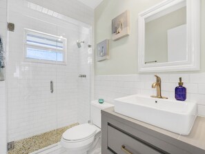 A bathroom with a shower, toilet, and sink. - Waterfront House in the heart of Cudjoe Key.  (Summerland Key)