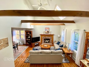 Cozy living space with a comfortable sofa, flat-screen TV, and fireplace.