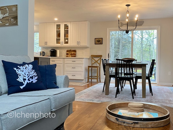 Relax in this inviting living area with a sofa, coffee table, and dining space.