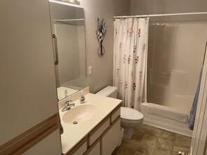 A bathroom with a sink, toilet, and shower area. - Escape To Branson! (Branson)
