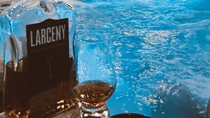 A hot tub with string lights, a bottle of Larceny whiskey, and a glass. - Hot Tub Beautiful Downtown Indy Home! (Indianapolis)