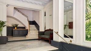 A grand staircase leading to a landing with a dark wooden bench and a potted plant. - Casa Cosi - Casanova 2 (Barcelona)